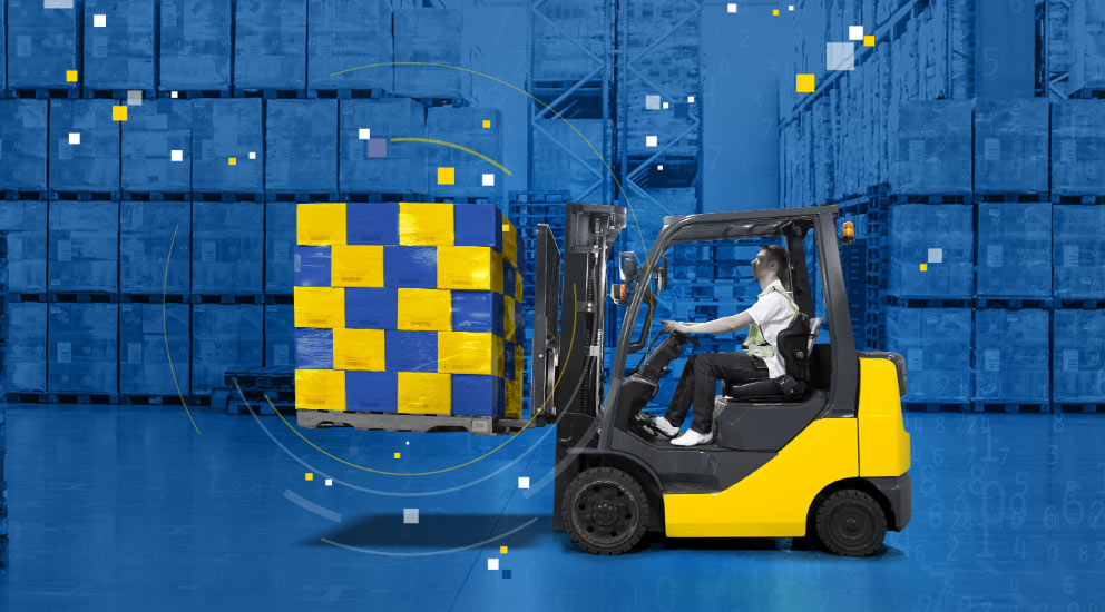 Warehouse interior with yellow forklift holding 20 blue and yellow boxes